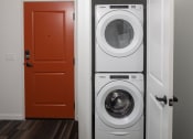 Thumbnail 53 of 84 - a white washer and dryer next to a red door at The Landing at 1001 NP, Fargo, North Dakota 58102