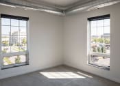 Thumbnail 54 of 84 - an empty room with two large windows at The Landing at 1001 NP, Fargo, ND 58102