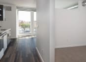 Thumbnail 60 of 84 - an empty kitchen and living room with a large window at The Landing at 1001 NP, Fargo, ND, 58102