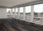 Thumbnail 61 of 84 - a living room with a large window and hardwood floors at The Landing at 1001 NP, Fargo, ND 58102