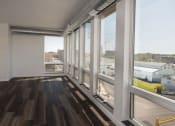 Thumbnail 62 of 84 - a living room with large windows and a wooden floor at The Landing at 1001 NP, Fargo, North Dakota 58102