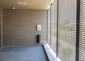 Thumbnail 69 of 84 - a hallway with a privacy screen and a trash can at The Landing at 1001 NP, Fargo, North Dakota 58102