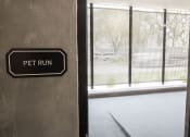 Thumbnail 70 of 84 - a sign that says pet run on the side of a building at The Landing at 1001 NP, Fargo, ND, 58102