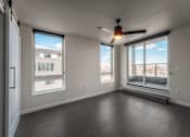 Thumbnail 19 of 36 - A room with a ceiling fan and large windows. at Unite Apartments, North Dakota, 58103