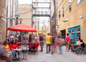 Thumbnail 7 of 37 - A city street filled with people and a red tent  at RoCo Apartments, Fargo, North Dakota, 58102