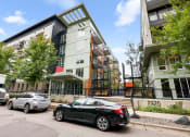 Thumbnail 26 of 86 - an apartment building with cars parked in front of it
