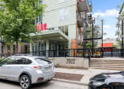 Thumbnail 28 of 86 - an apartment building with a silver car parked in front of it