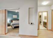 Thumbnail 9 of 86 - a bedroom with a bed and a bathroom with a mirror