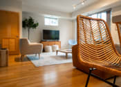 Thumbnail 7 of 86 - a living room with a wooden chair in front of a television