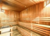 Thumbnail 25 of 86 - a sauna in a wooden room with wooden walls and a table