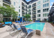 Thumbnail 16 of 86 - a swimming pool in front of an apartment building