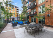 Thumbnail 22 of 86 - an outdoor patio with tables and chairs in front of a building
