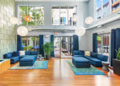 Thumbnail 15 of 86 - the lobby of a building with blue couches and blue rugs
