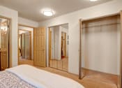 Thumbnail 9 of 32 - A bright bedroom closet area here at Windsong featuring spacious mirrored sliding doors and ample storage. Clean, open layout with soft carpet and convenient access to the adjoining bedroom and bathroom areas.