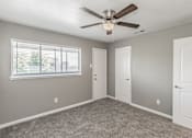 Thumbnail 25 of 31 - Bedroom with ceiling fan and neutral tones at Chapel Creek Apartments Dallas