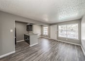 Thumbnail 29 of 31 - Kitchen with dark cabinets and granite-style countertops at Chapel Creek Apartments Dallas