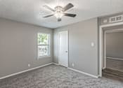 Thumbnail 14 of 17 - Bedroom with ceiling fan and plush carpet at Davis Park Apartments