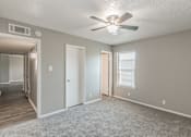 Thumbnail 5 of 17 - Bedroom with ceiling fan and plush carpet at Davis Park Apartments