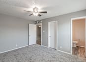 Thumbnail 16 of 17 - Bedroom with ceiling fan and plush carpet at Davis Park Apartments