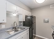 Thumbnail 1 of 17 - Kitchen with gas range and refrigerator at Davis Park Apartments in North Richland Hills TX
