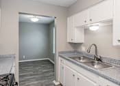 Thumbnail 11 of 17 - Kitchen with gas range and refrigerator at Davis Park Apartments in North Richland Hills TX