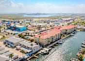 Thumbnail 41 of 42 - A view of a marina with boats docked in the water.