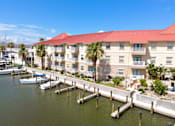 Thumbnail 25 of 25 - A marina with boats and a building with a red roof.