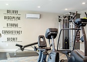 Thumbnail 9 of 11 - A gym with a wall that has the words Believe, Discipline, Strong, Consistency, and Secret written on it.