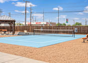 Thumbnail 4 of 11 - A tennis court with a blue surface and a wooden fence.