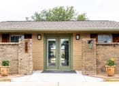 Thumbnail 2 of 5 - the front entrance of a brick building with green doors