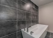 Thumbnail 26 of 30 - Large soaking tub and tile surround in luxury bathroom at Reserve on Abrams