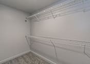 Thumbnail 28 of 30 - Large walk-in closet with built-in shelving at Reserve on Abrams Dallas