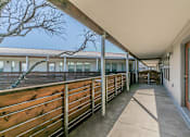 Thumbnail 27 of 30 - Private patio with wood railing overlooking courtyard at Reserve on Abrams