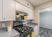 Thumbnail 2 of 17 - Kitchen with gas range and refrigerator at Davis Park Apartments in North Richland Hills TX