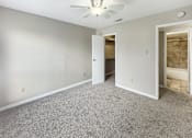 Thumbnail 8 of 19 - A room with a carpeted floor and a ceiling fan.