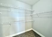 Thumbnail 16 of 25 - Empty room with white walls and shelves.
