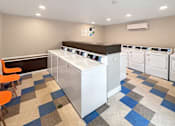 Thumbnail 13 of 17 - A laundry room with a washer and dryer.