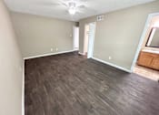 Thumbnail 4 of 17 - A room with wooden flooring and a ceiling fan.