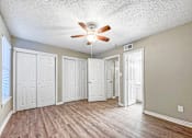 Thumbnail 22 of 28 - Bedroom with ceiling fan and large window at Verano Oaks Apartments