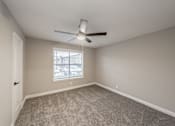 Thumbnail 20 of 39 - Bedroom with carpet flooring and ceiling fan at Riata Park Apartments