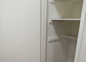 Thumbnail 11 of 36 - A white bathroom with a towel hanging on the wall at Raintree Apartments, CA 92346