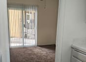 Thumbnail 10 of 36 - A hallway with a bedroom at the end at Raintree Apartments, CA 92346