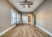 Thumbnail 14 of 20 - a living room with hardwood floors and a ceiling fan