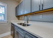 Thumbnail 12 of 20 - a kitchen with a sink and a window