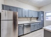 Thumbnail 20 of 20 - a kitchen with gray cabinets and stainless steel appliances