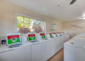 Thumbnail 28 of 29 - a laundry room with white washers and dryers
