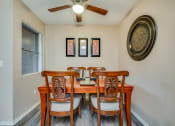 Thumbnail 23 of 29 - a dining room with a table and four chairs