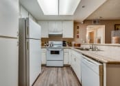 Thumbnail 24 of 29 - a kitchen with white cabinets and white appliances