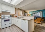 Thumbnail 22 of 29 - a kitchen with white cabinets and a white dishwasher