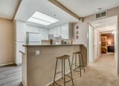 Thumbnail 21 of 29 - a kitchen with a breakfast bar and stools